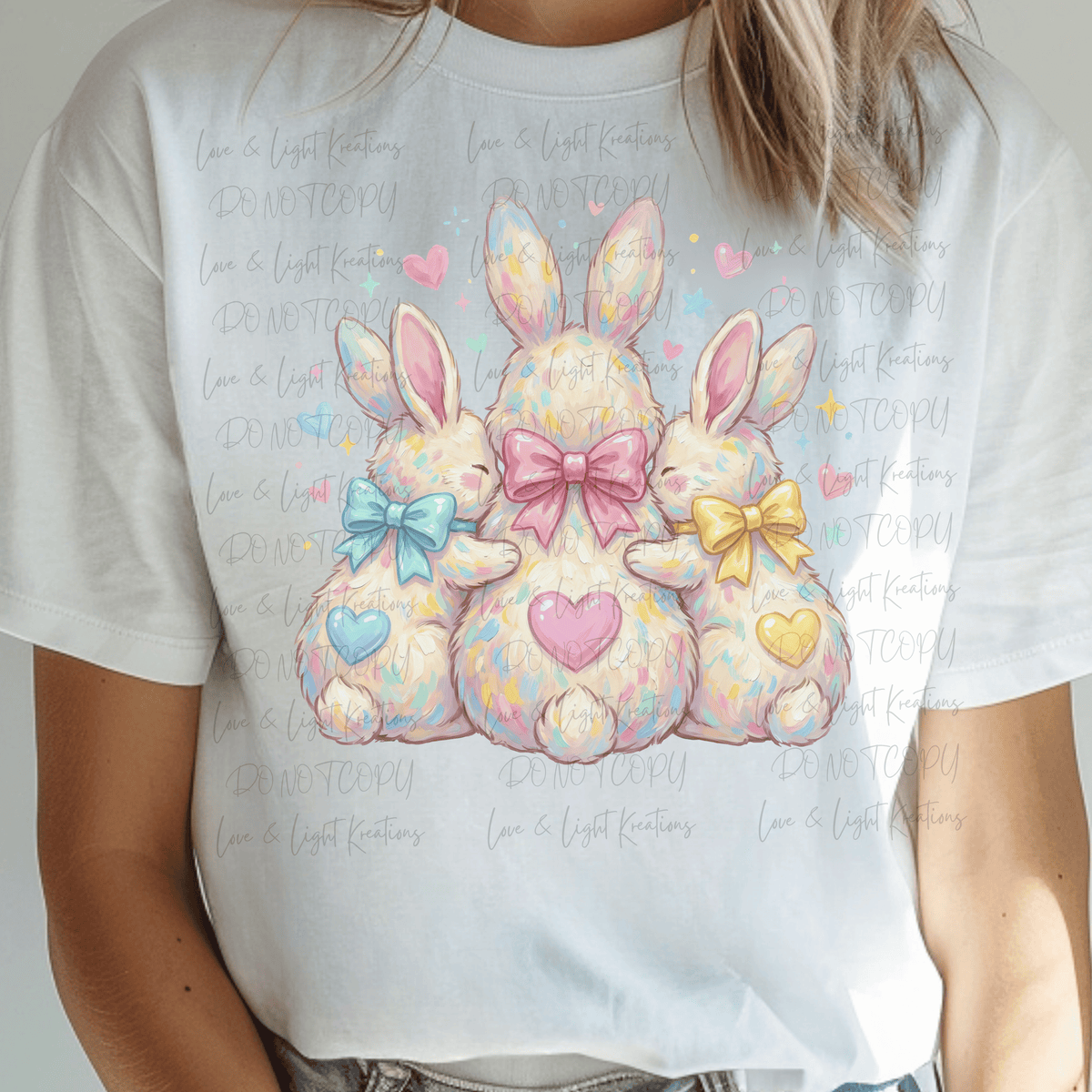 Three Easter Bunnies with Blue, Pink and Yellow Hearts and Bows